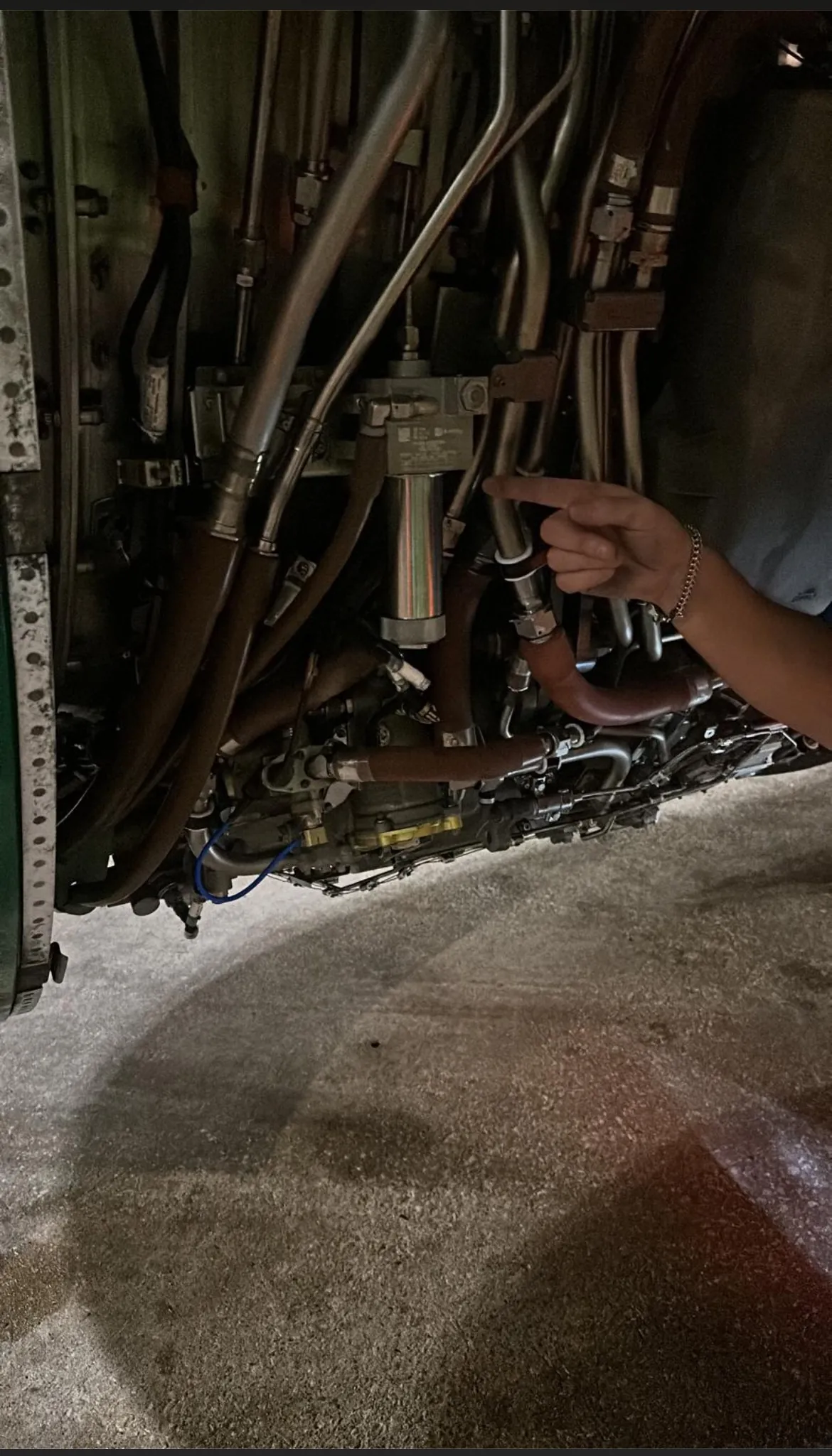 Pointing out a hose fitting on an engine